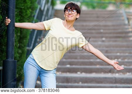 Funny Happy Middle-aged Woman In An Urban Park.