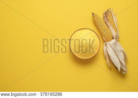 Above View With A Bowl Of Cornflour Isolated On A Yellow-colored Background. Organic Polenta Top Vie