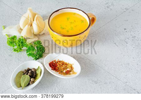 Homemade Chicken (bone) Broth/bouillon With Vegetables, Spices And Herbs In A Bowl (cup) On A Light 