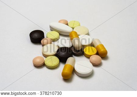 Colorful Pills And Capsules On White Background Close Up, Macroshot Tablets, Isolated. Pandemic Medi