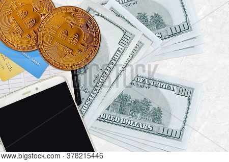 100 Us Dollars Bills And Golden Bitcoins With Smartphone And Credit Cards. Cryptocurrency Investment