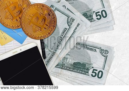 50 Us Dollars Bills And Golden Bitcoins With Smartphone And Credit Cards. Cryptocurrency Investment 