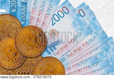 2000 Russian Rubles Bills And Golden Bitcoins. Cryptocurrency Investment Concept. Crypto Mining Or T
