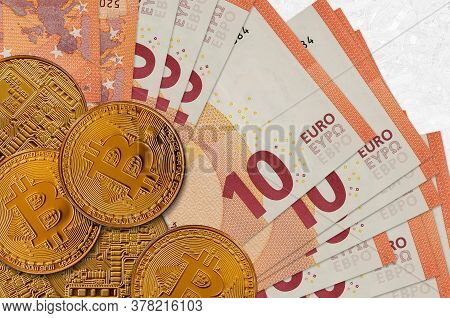 10 Euro Bills And Golden Bitcoins. Cryptocurrency Investment Concept. Crypto Mining Or Trading