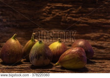 Fresh Fig Fruits (ficus Carica L.) With Peel On A Piece Of Aged Wood