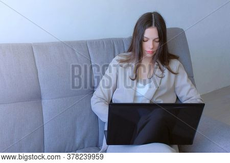 Freelancer Woman Working Typing On Laptop At Home Sitting On Couch, Freelance Distant Work On Quaran