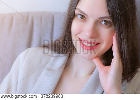 Portrait Of Woman Looking At Camera And Smiling At Home Sitting On Couch, Freelance Distant Work On 