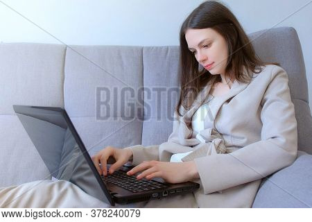 Freelancer Woman Working Typing On Laptop At Home Sitting On Couch, Freelance Distant Work On Quaran