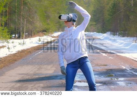 Woman In Cap Dancing In Forest On Country Road Uses Vr Googles Waving Hands. Playing Games Or Watchi