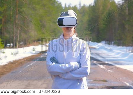 Portrait Of Woman In Forest On Country Road In Vr Googles Standing And Watching. Playing Games Or Wa