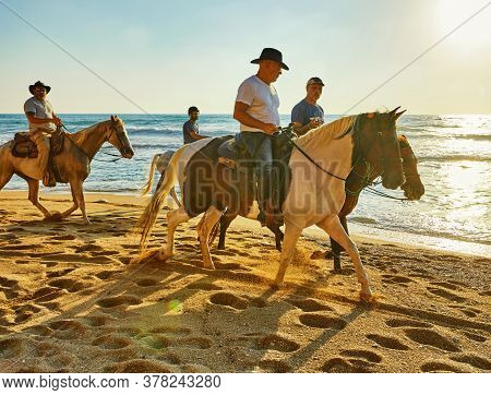 Arsuf, Israel - July 22, 2020: Horseback Riding Along The Mediterranean Sea Coast At Sunset.