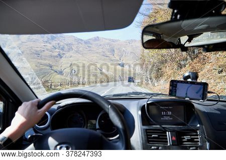 Tbilisi, Georgia - October 25, 2019: Car Vindow, Hand Of Woman On Steering Wheel And View To The Roa