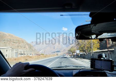Tbilisi, Georgia - October 25, 2019: Car Vindow, Hand Of Woman On Steering Wheel And View To The Roa