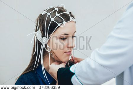 Doctor And Patient With Encephalography Electrode. Electroencephalogram