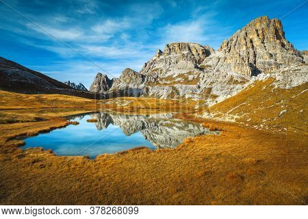 Alpine Autumn Landscape With Breathtaking Mountain Lake Lago Dei Piani. Mountain Ridge Reflection In