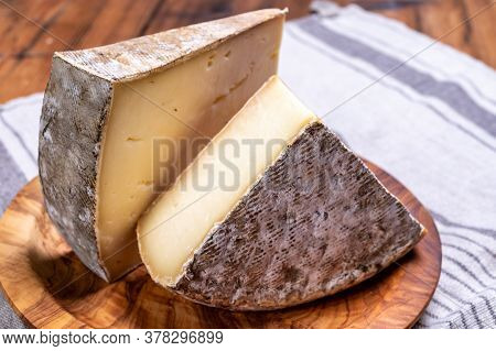 Pieces Of Cheese Tomme De Montagne Or Tomme De Savoie Made From Cow Milk In French Alps.