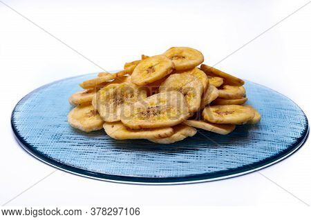 Healthy Sweet Snack, Crispy Dehydrated Unsugared Banana Chips On Recycled Glass Plate On White Backg