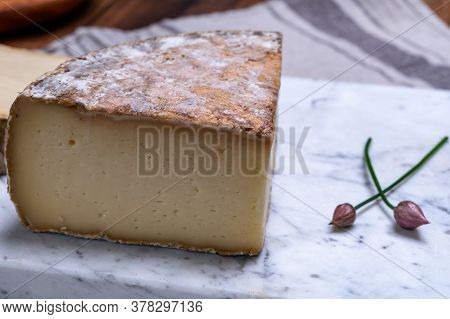 Pieces Of Cheese Tomme De Montagne Or Tomme De Savoie Made From Cow Milk In French Alps.