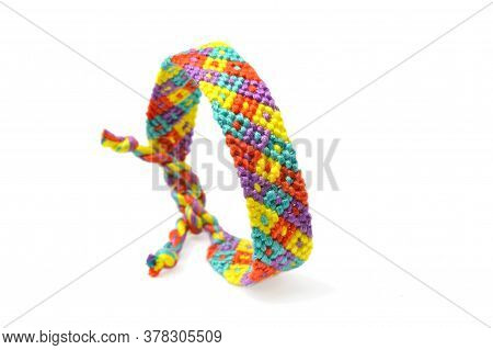 Selective Focus Of Tied Woven Friendship Bracelet With Bright Colorful Pattern Handmade Of Thread Is