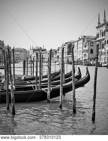 View of the Grand Canal with moored gondolas in Venice, Italy. Black and white photography