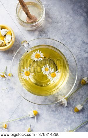 Chamomile Flowers And Chamomile Tea In Glass Teacup, Top View, Prevention Of Seasona Flu Colds