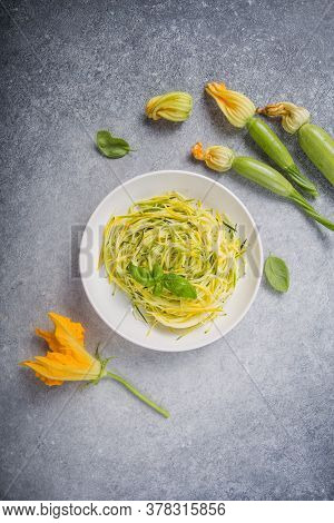 Zucchini Vegetable Noodles - Green Zoodles Or Courgette Spaghetti On Plate Over Gray Background. Cle