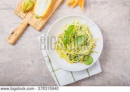 Zucchini Vegetable Noodles - Green Zoodles Or Courgette Spaghetti On Plate Over Gray Background. Cle