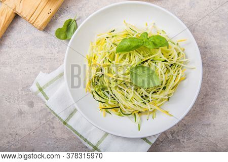 Zucchini Vegetable Noodles - Green Zoodles Or Courgette Spaghetti On Plate Over Gray Background. Cle