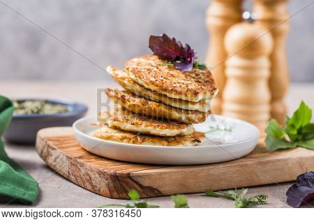 Vegetarian Zucchini Fritters Or Pancakes Stack Topped With Sour Cream And Cilantro. Vegetable Pancak
