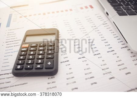 Calculator With Financial Statements On A White Background