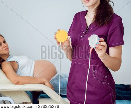 Pregnant Woman With Electrocardiograph Check Up For Her Baby