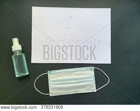 A White Sheet Of Paper With An Inscription On A White Sheet, Antiseptic And Protective Mask On A Bla