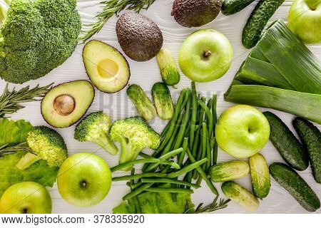 Green Vegetables Background. Сucumber, Avocado, Broccoli, Beans, Leek And Fresh Apple On White Woode