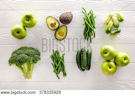 Green Vegetables Background. Сucumber, Avocado, Broccoli, Beans, Leek And Fresh Apple On White Woode
