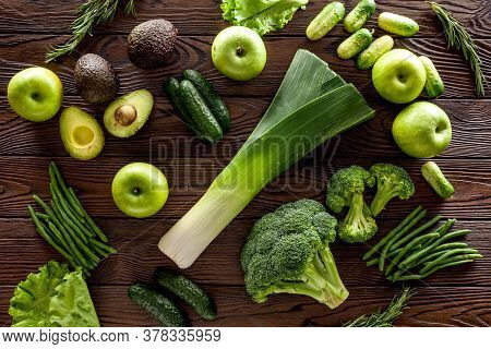 Green Vegetables Background. Сucumber, Avocado, Broccoli, Beans, Leek And Fresh Apple On Dark Wooden