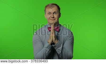 Handsome Man Hands In Prayer And Begging, Asking Permission Heartily, Looking At Camera With Implori