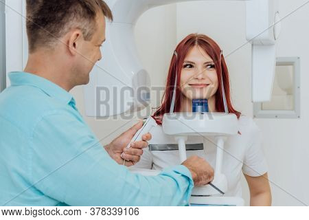 A Girl Patient Makes A Panoramic X-ray Of The Oral Cavity On An Orthopantomographic Apparatus, And T