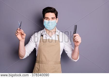 Portrait Of His He Attractive Guy Barber Wearing Safety Mask Holding In Hands Scissors Comb Social D
