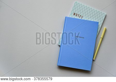 Two Blue Notepads With Pen On A Blue Paper Background. Top View. Close-up. Flat Lay.