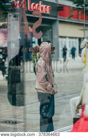 Manchester, England, Uk - 24 July, 2020 City Centre Of Manchester, Young Girl In Face Mask Is Lookin