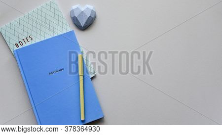 Two Blue Notepads With Pen On A Blue Paper Background. Top View. Close-up. Flat Lay.