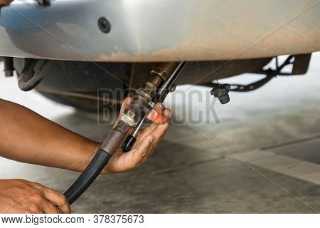 Auto Refuel. Car At Gas Station Being Filled With Fuel. The Car Is Filling Lpg With Nozzles, Liquid 