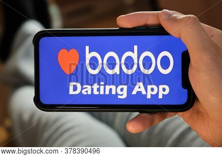 Badoo Application On The Smartphone In Mans Hand. Man Laying And Using Application For Dating And Me