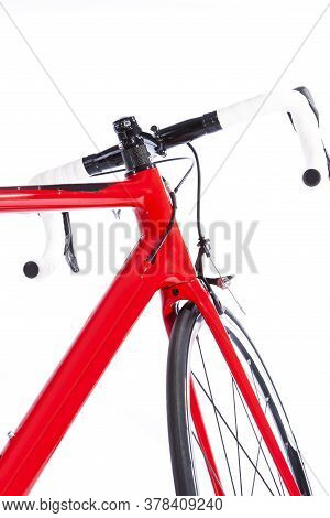 View Of Front Wheel Of Modern Road Bike Against White. Vertical Image