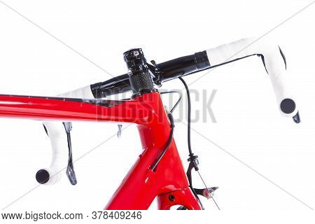 View Of Handlebars Of Modern Carbon Road Bike Against White. Horizontal Image