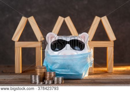 Pandemic Real Estate Crisis. Masked Piggy Bank