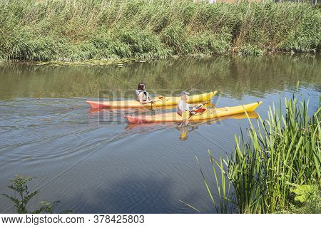 Lokeren, Belgium, 13 July 2020, Couple Sail Peacefully Side By Side In A Canoe On The River Durme