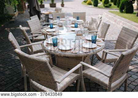 Served Table Set At Suumer Terrace. Cutlery In Cafe. Green Background