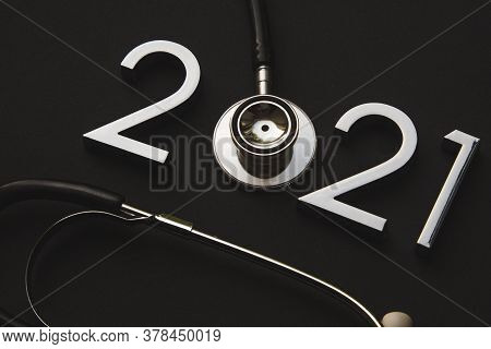 Stethoscope With 2020 Silver Number On Black Background. Happy New Year For Healthcare And Medical B