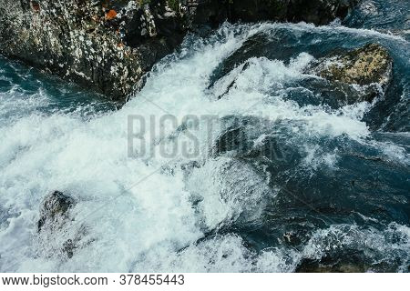 Big Stones In Azure Water Of Mountain River Close-up. Blue Nature Background With Big Boulders In Tu
